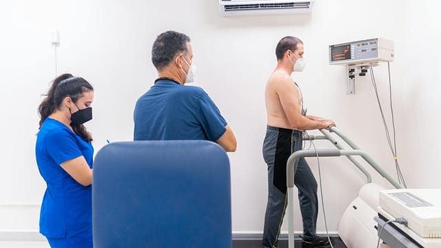 a cardiologist examining a patient undergoing cardiac stress test