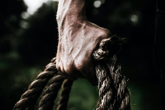 man holding brown rope